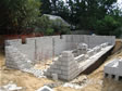 Cement block construction is underway for this basement foundation in progress