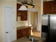 Center island with granite countertop and small built-in sink, makes working in this space a pleasure