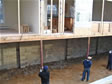 Lolly columns being installed in the full basement of a Monmouth County, modular home