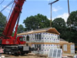 Modular home installation day of set using a 110 ton crane to lift modular units onto foundation