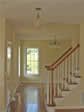 View into the living room shows rounded baluster stair railings in this RBA modular home