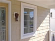A small decorative framed window on the porch adds a nice touch to this front elevation