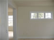 High, triple transom casement windows allow light in and leave plenty of wall space for furniture