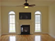 This Oceanport, NJ home features circle top windows on each side of the living room fireplace