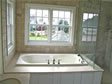 Jacuzzi/whirlpool tubs surrounded by windows add light and beauty to any bathroom by RBA Homes