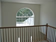 Placing a decorative circle top window above the front door adds light into a foyer and 2nd floor hall