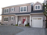 Recessed front door entry provides distinctive look and sets this home apart from other modular homes. 	A one car garage was important for storage space, for this home located on the Jersey Shore.